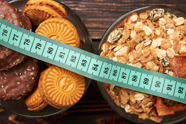 Muesli cookies and measuring tape Healthy and unhealthy food