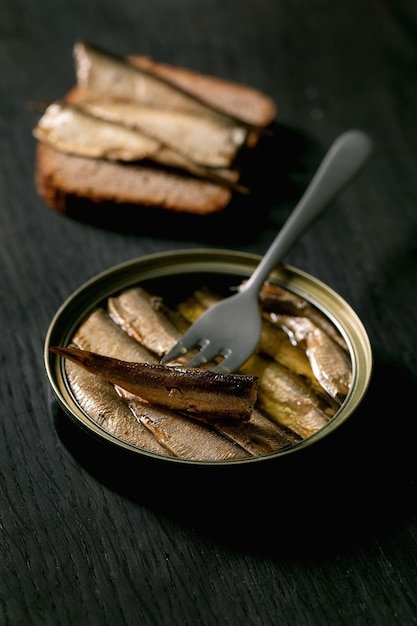 Open can with canned sprats in oil