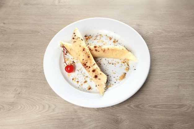 The original blueberry cheesecake on white plate on wooden background