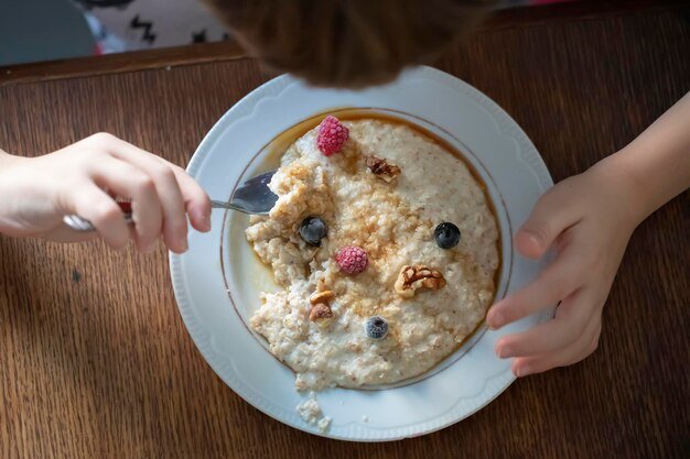 Plate with oatmeal with berries top view