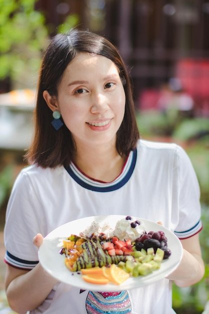 Portrait of woman holding plate with food