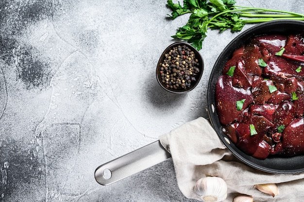 Raw turkey liver in a frying pan