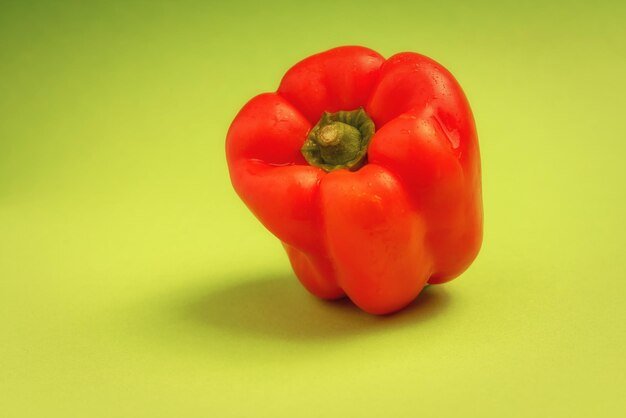 Red paprika with green background