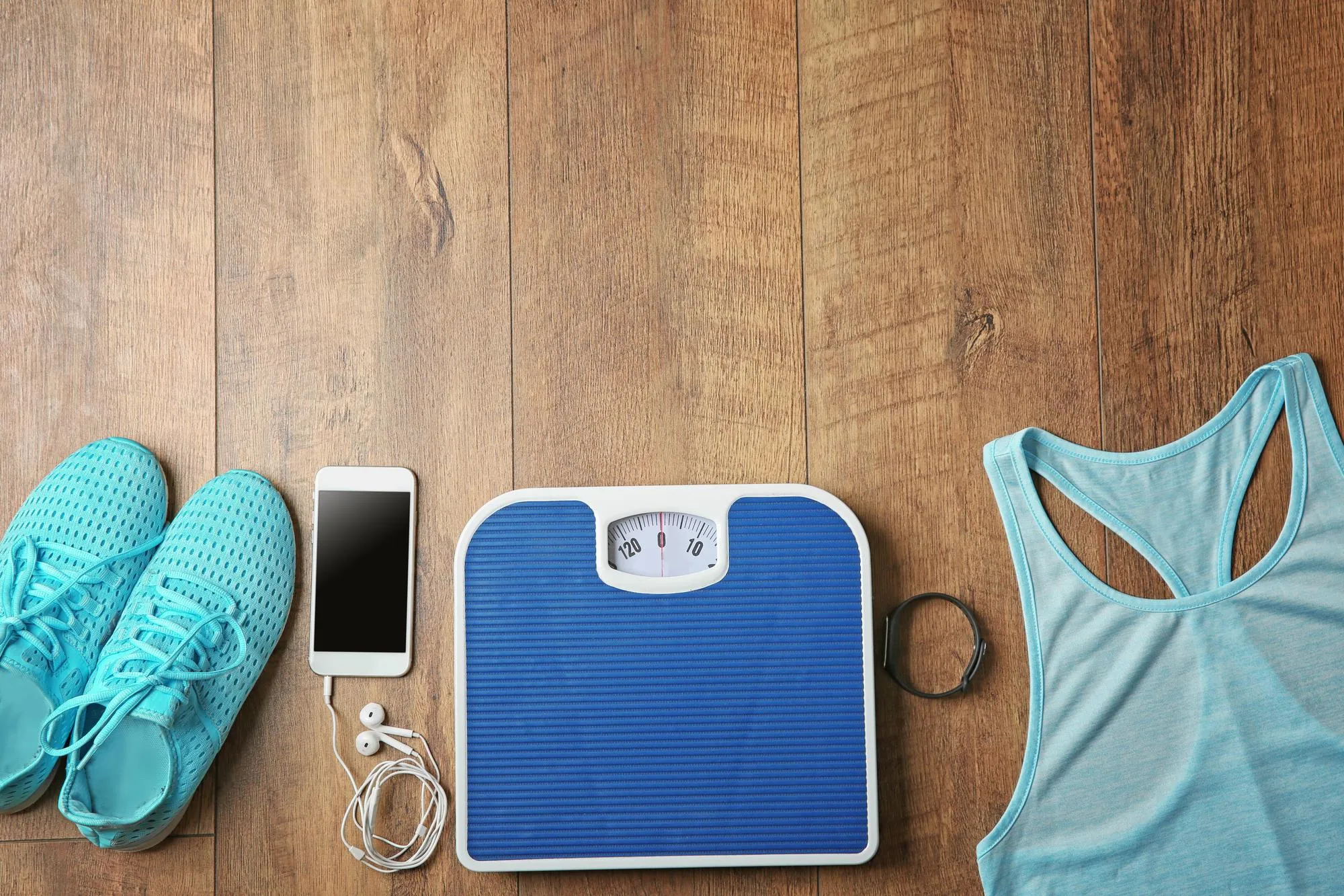 Sport clothes and equipment on wooden background