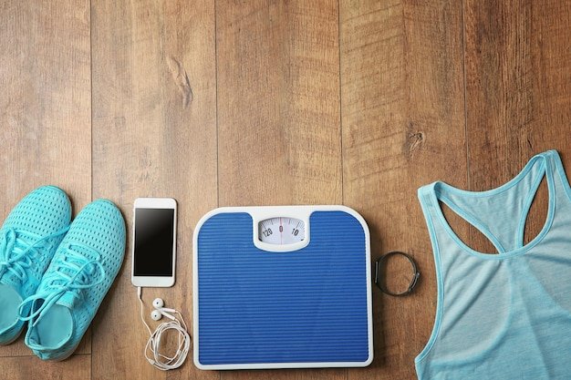 Sport clothes and equipment on wooden background