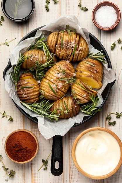 Top view of potatoes in pan with rosemary and spices