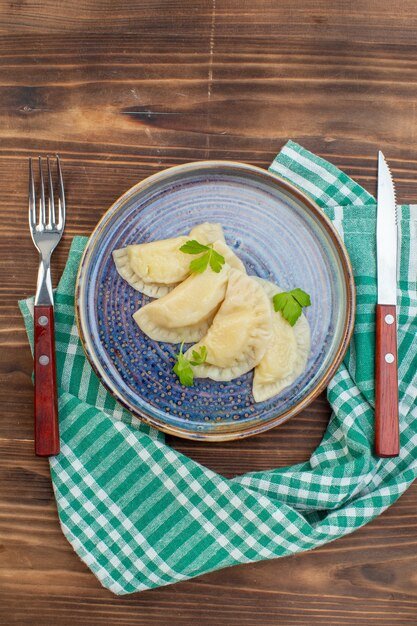 top view tasty cooked hotcakes inside tray with cutlery on brown wooden desk cooking meal pie oven cake biscuit pastry cuisine dough