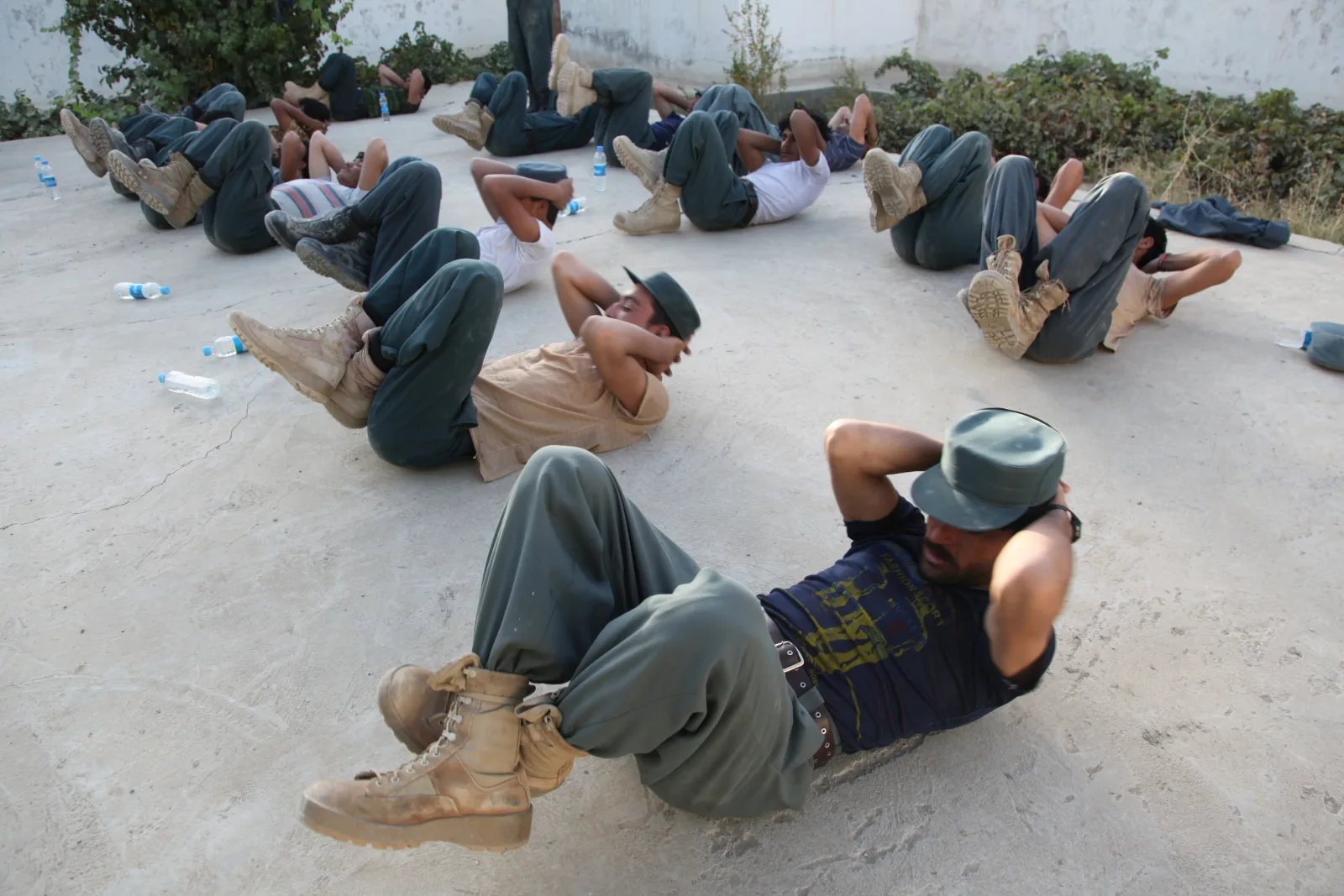 Afghan Local Police (ALP) trainees perform abdominal exercises during police academy training at the Musa Qala District Center in Helmand province, Afghanistan, Oct. 2, 2012. ALP trainees began their second day of training with a physical training session. (DoD photo by Staff Sgt. Raul Gonzalez, U.S. Marine Corps/Released)