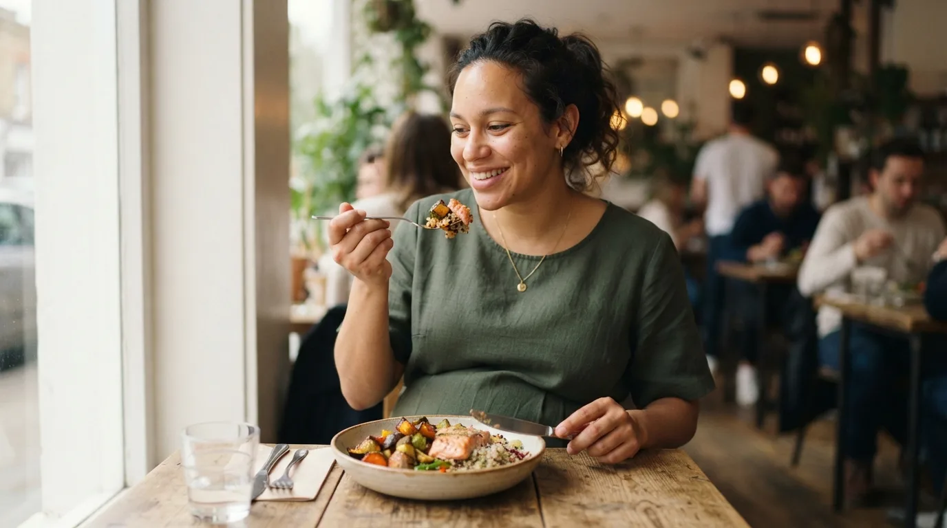 a pregnant woman eating a meal
