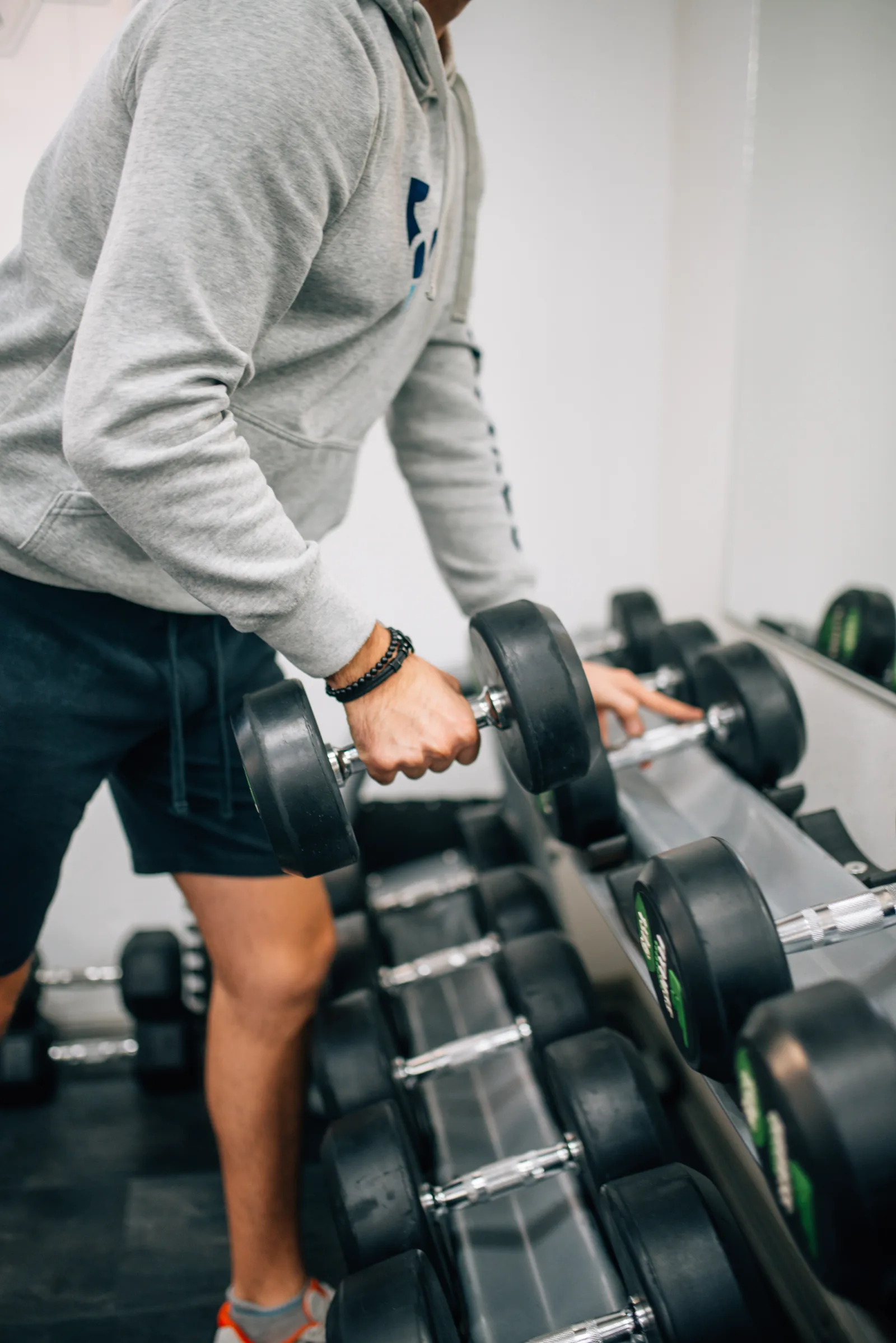 Man lifting dumbbell weight for exercise in fitness gym