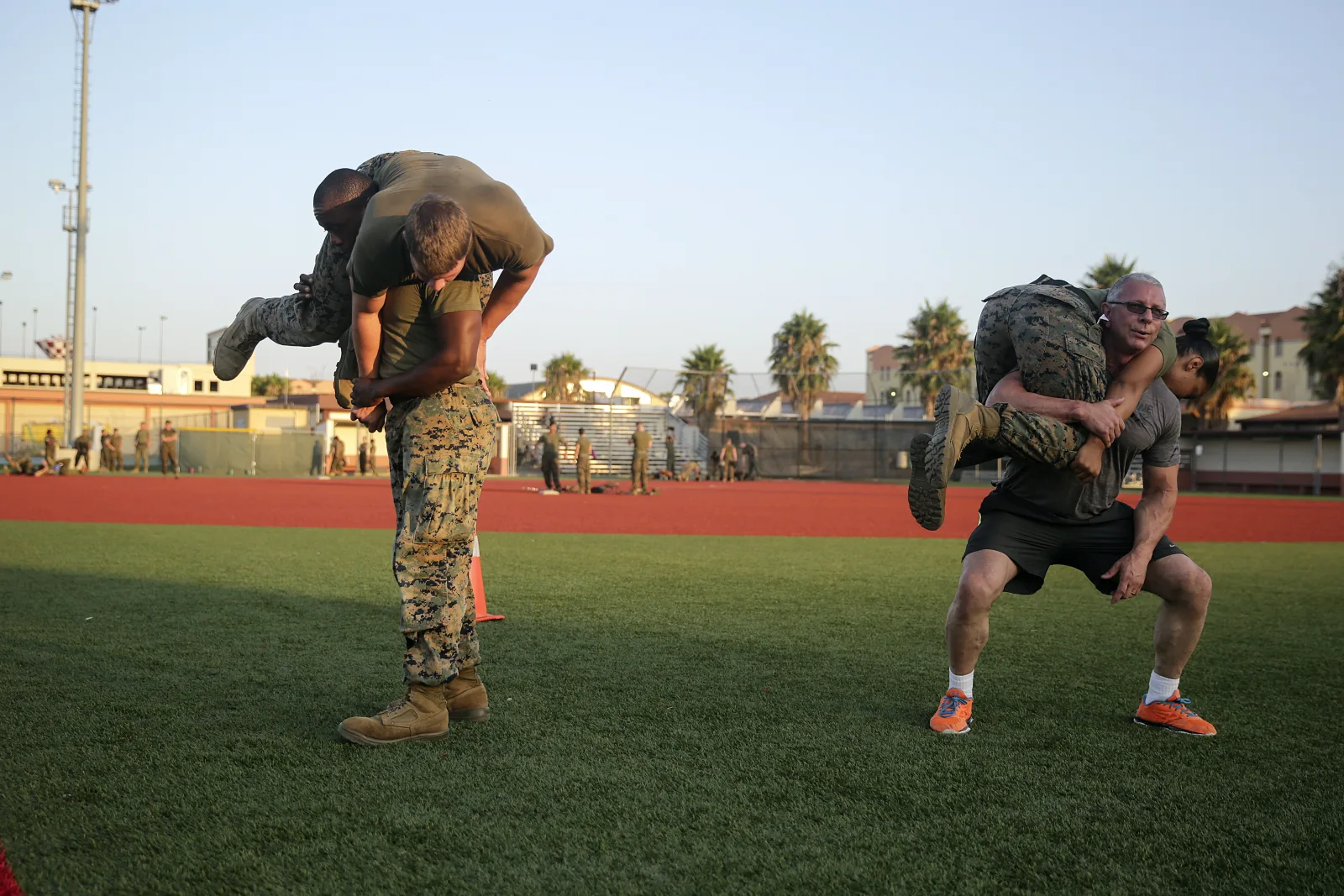 Celebrity Chef Robert Irvine and Marines with Special Purpose Marine Air-Ground Task Force Crisis Response-Africa conduct buddy squats during a physical training event at Naval Air Station Sigonella, Italy, July 28, 2016.  Marines completed a circuit course with Irvine, which included upper and lower body workouts, Marine Corps Martial Arts Program techniques and laps around the baseball field.  (U.S. Marine Corps photo by Cpl. Alexander Mitchell/released)
Unit: U.S. Marine Corps Forces Europe and Africa