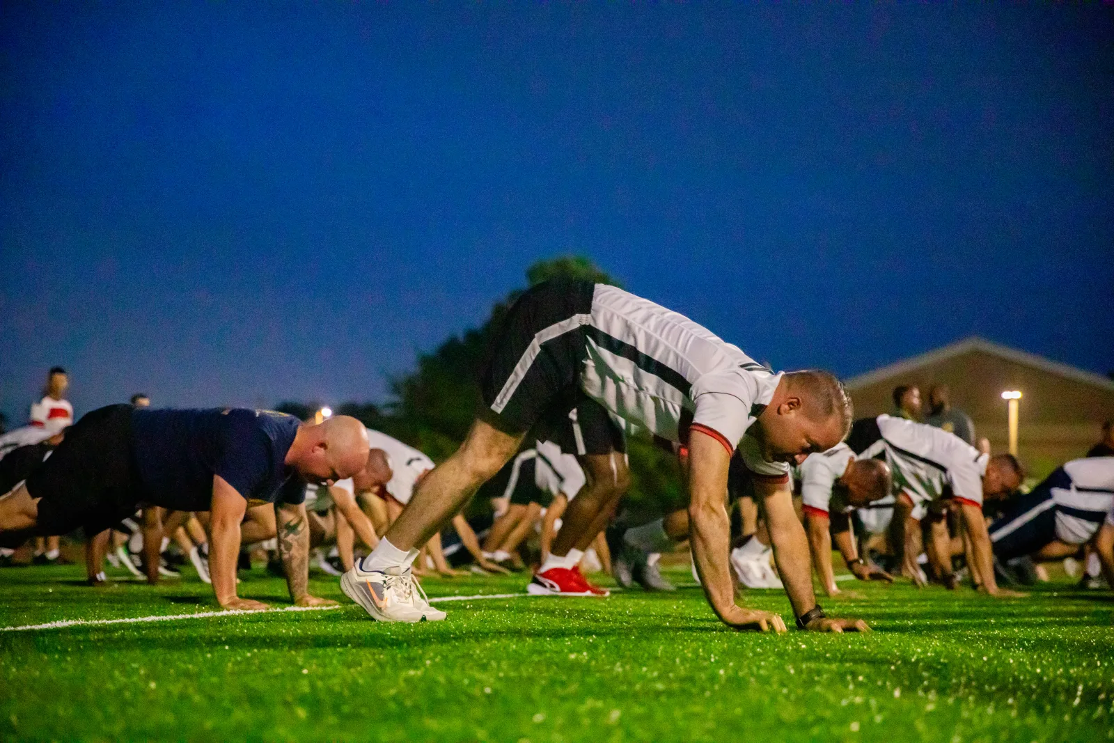 Colombian army Sergeant Major of the Army Diego Rodriguez Arias, center, and other Programa Integral para Suboficiales de Alta Jerarquía (PISAJ) 21 participants and facilitators from the U.S. and Colombian militaries from the U.S. Army, U.S. Air Force and Colombian military conduct physical training with Holistic Health and Fitness Academy instructors at Fort Jackson, S.C., Aug. 12, 2025. PISAJ is a biannual, partner nation-funded initiative aligned with U.S. Southern Command’s Theater Campaign Plan and directly supports the Colombian army's transformation to align its noncommissioned officer corps with globally recognized standards. (U.S. Army photo by Staff Sgt. Joshua Taeckens)