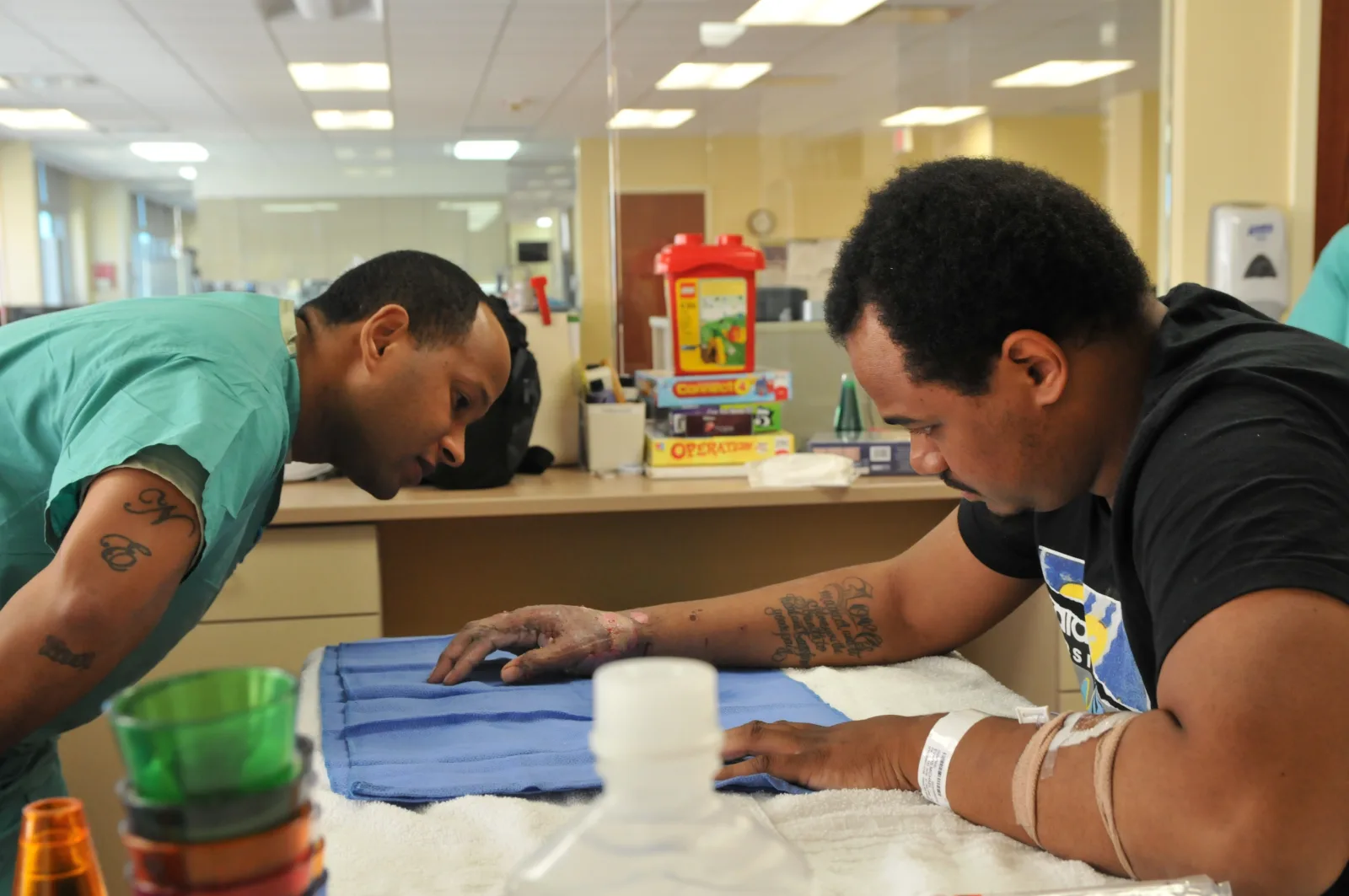 Spc. Kirk Matthews, an Army physical therapist technician with the U.S. Army Institute of Surgical Research Burn Center, demonstrates hand movement exercises for a patient to perform during a therapy session Feb. 24 at Fort Sam Houston, Texas. Physical therapy is a crucial step treating burn patients forcing the healing skin to stretch and contract with normal motion during the healing process. (U.S. Army Photo by Sgt. Aaron Ellerman, 204th Public Affairs Detachment/Released)
Unit: 204th Public Affairs Detachment
DVIDS Tags: Soldier; medical; Photo; prevention; treatment; optometry; improvement; measure; blood; patient; testing; technician; burn; rehabilitation; research; assessment; injury; casualty; CAT; trauma; dr.; tourniquet; picture; Photojournalist; wound; TCCC; aids; diagnosis; Public Affairs; Army Reserve; Texas; medic; doctor; study; fort Sam Houston; physical therapy; san Antonio; Army; training; lab; specialist; ICU; surgical; skin; worldwide; deployable; Medcom; exposure; model; biomedical; heal; shock tube; 204th PAD; innovation; Joint Base San Antonio; results; burn center; MRMC; Combat care; Medical Research and Material Command; Exercise News Day; Newsday 2016; photograph treatment; U.S. Army Institute Surgical Research; USAISR; BICU; flight team; ReCell; combat gauze; Xstat; ocular research; Damage Control Resuscitation of Severely Injured Soldiers