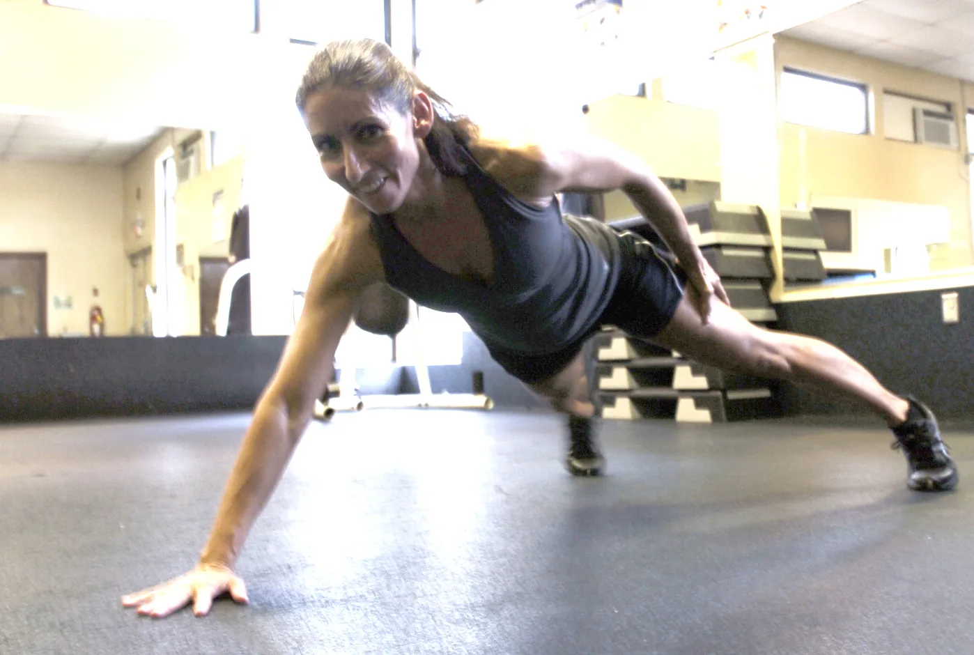 Winterhalter does a one-armed pushup during a workout at the Fort McPherson gym in preparation for an upcoming fitness competition. The one-arm pushup is one of the moves that must be incoporated into a two-minute routine. Other moves include the front split, high kicks, straddle hold and L-sit. Competitors perform the routine in costume to music based on a certain theme. For the upcoming fall classic, Winterhalter's theme will be Speed Racer.