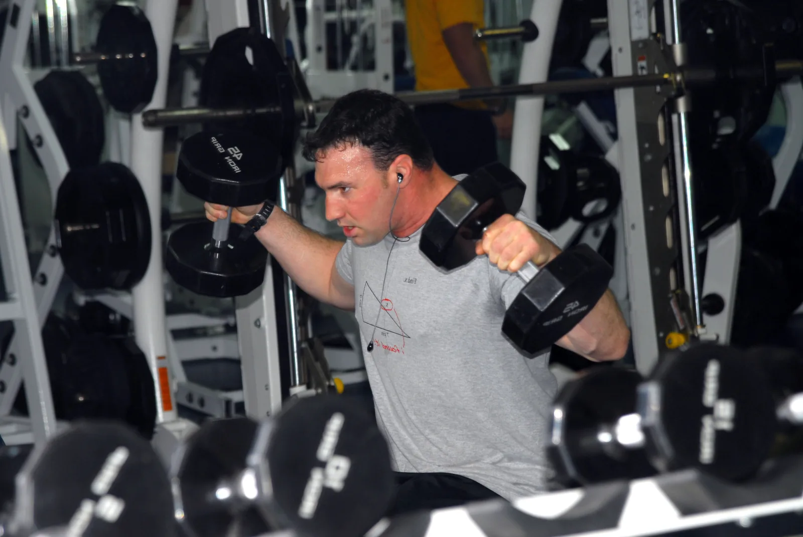 PACIFIC OCEAN (May 30, 2009) Hospital Corpsman 2nd Class Christian Kahle, assigned to Explosive Ordnance Disposal Mobile Unit (EODMU) 11, Platoon 1131, does shoulder press exercises during an upper-back training routine aboard the aircraft carrier USS Nimitz (CVN 68). Nimitz and Carrier Air Wing (CVW) 11 are conducting a Composite Training Unit Exercise off the coast of Southern California in preparation of a scheduled deployment to the western Pacific Ocean. (U.S. Navy photo by Mass Communication Specialist 3rd Class Matthew C. Haws/Released)