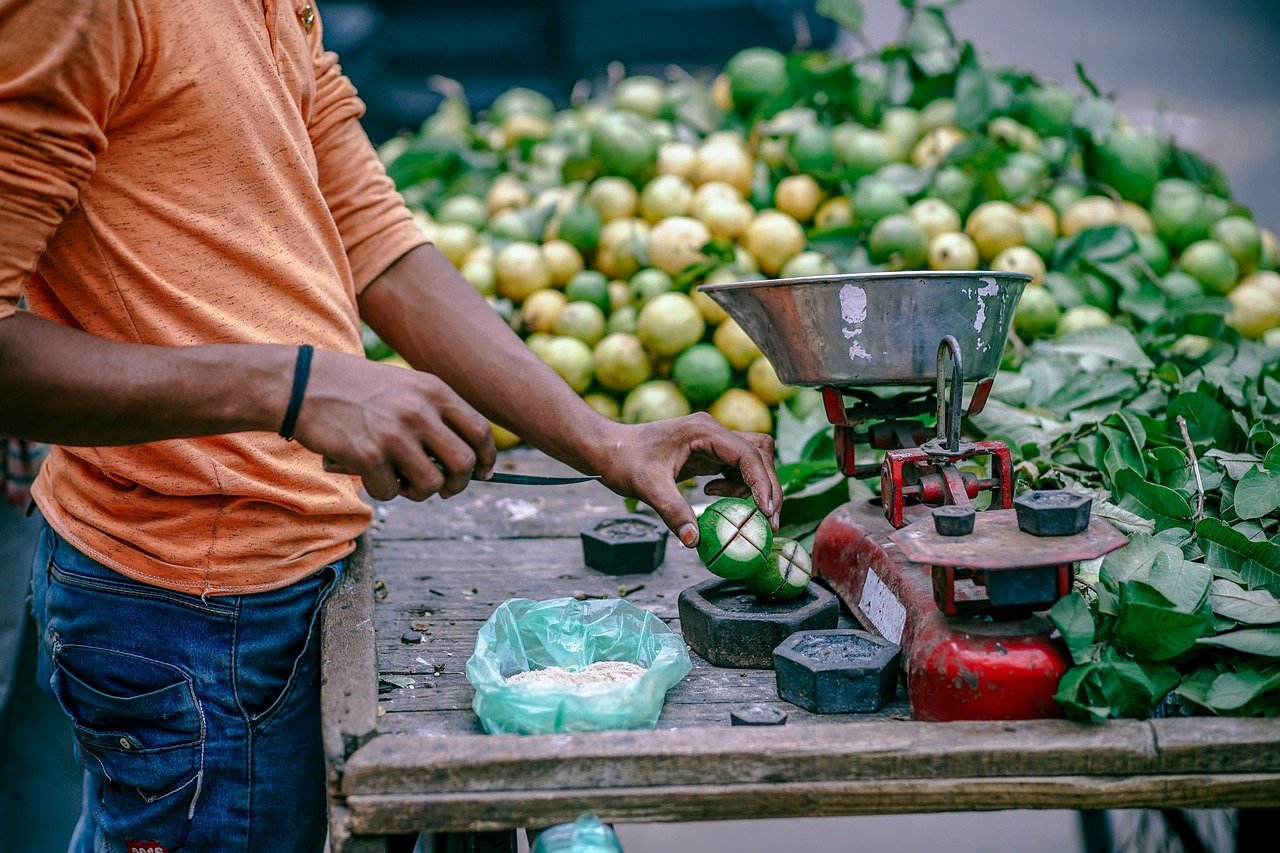 people, man, market, vendor, fruits, green, weighing scale, wood, table, weighing scale, weighing scale, weighing scale, weighing scale, weighing scale