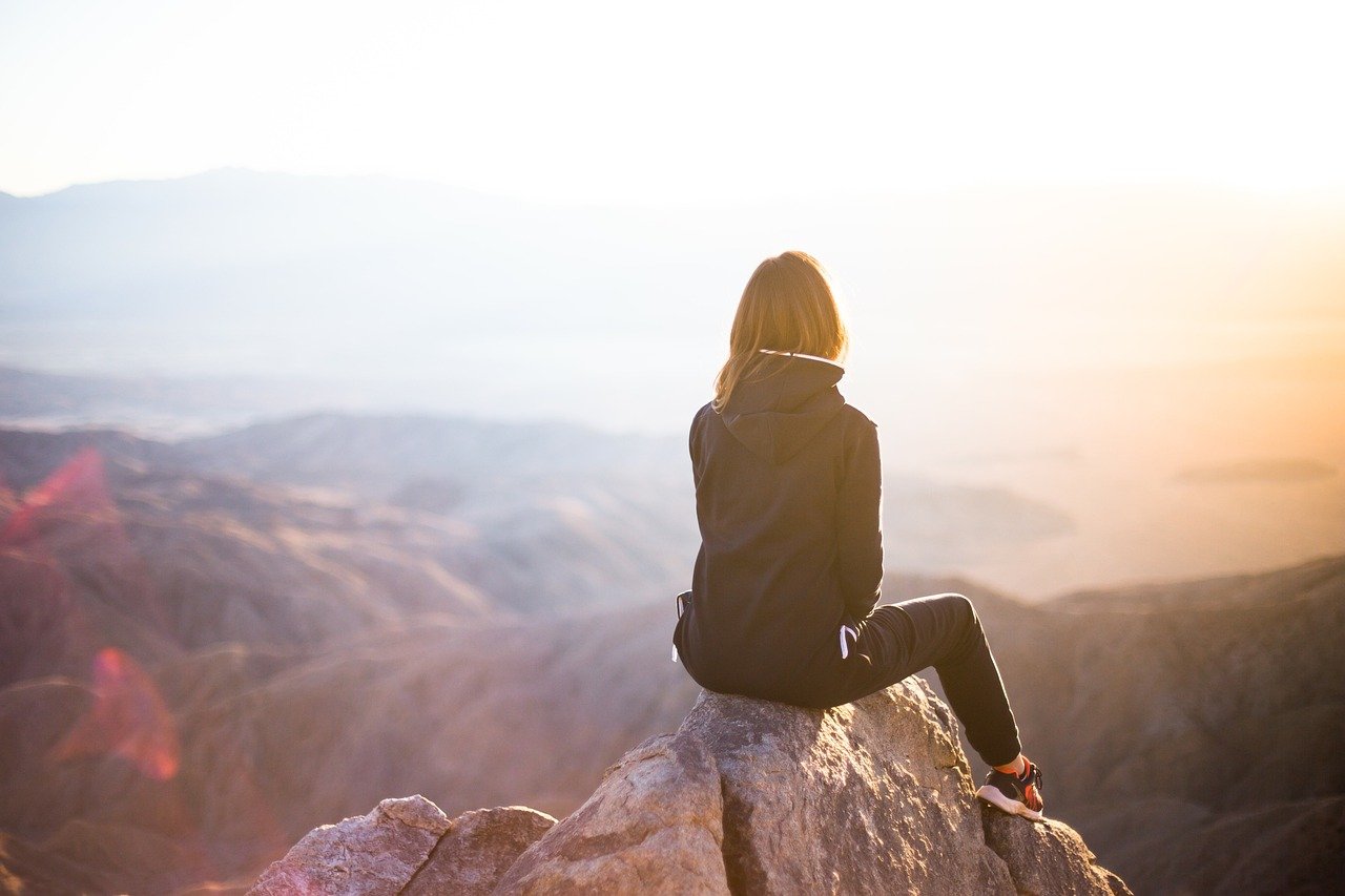 people, woman, travel, adventure, trek, nature, mountain, rock, sunset, cliff, black, hoodie, jacket, alone, thinking, freedom