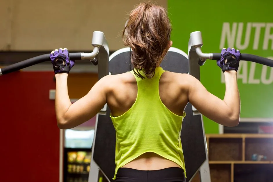 Woman in gym working out on exercise machine for a healthy lifestyle.