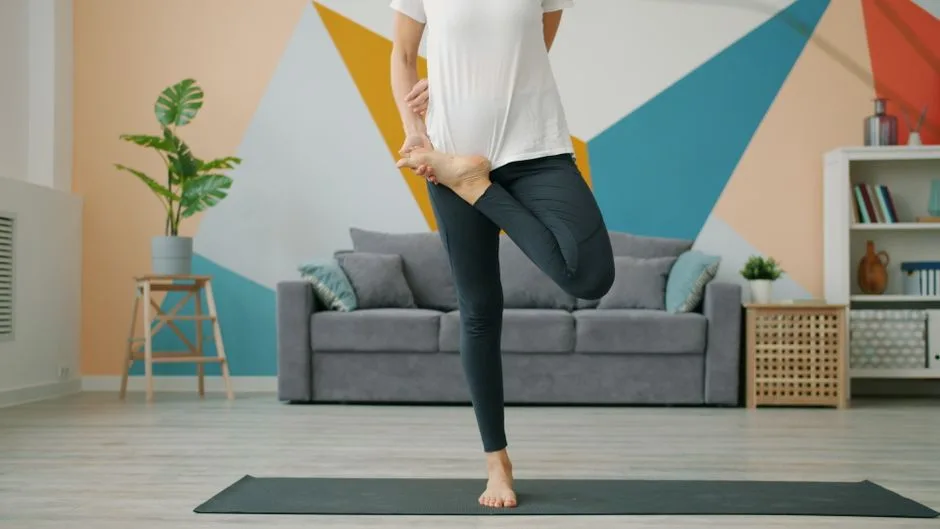 Adult practicing yoga pose in a stylish modern living room with geometric wall design.