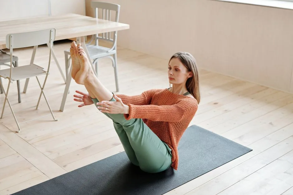 Woman practicing yoga in living room, enhancing balance and flexibility