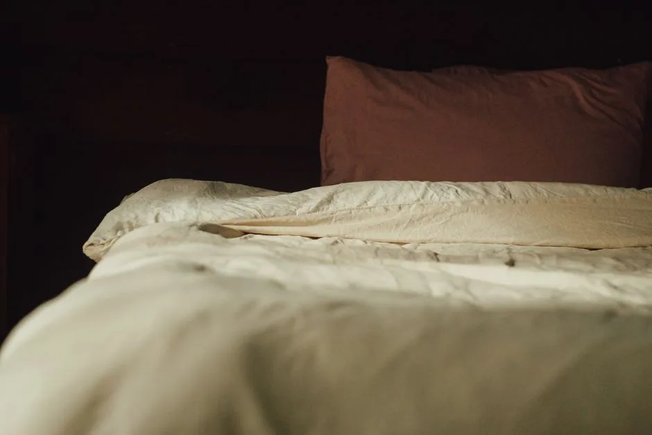 Warm and inviting bedroom setting featuring plush pillows and soft linen bedding.