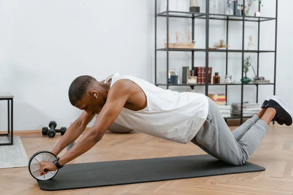 Young man working out with an ab roller on a yoga mat to improve core strength.