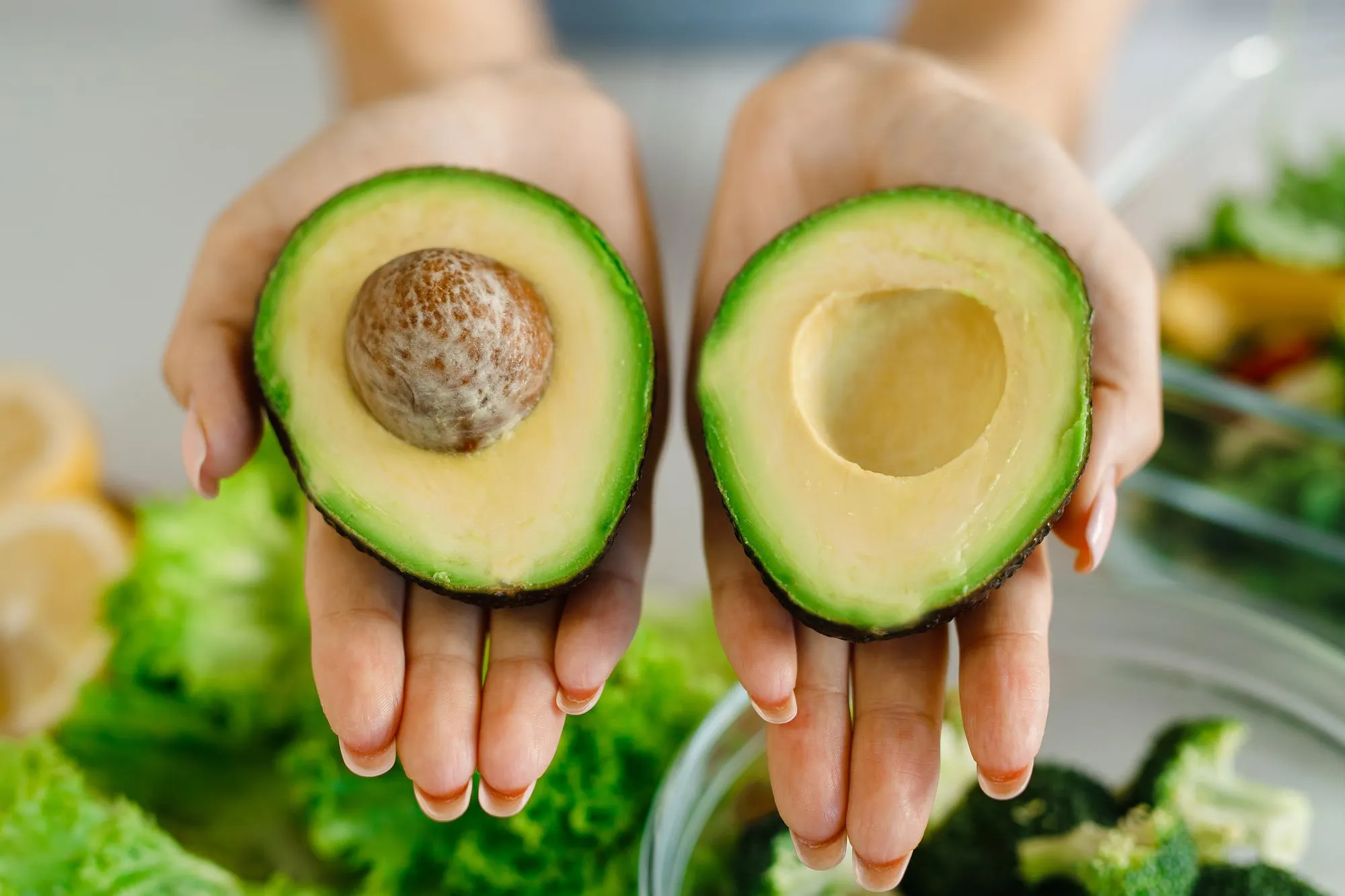 Woman holding avocado closeup Healthy eating conceptNutrition lessons
