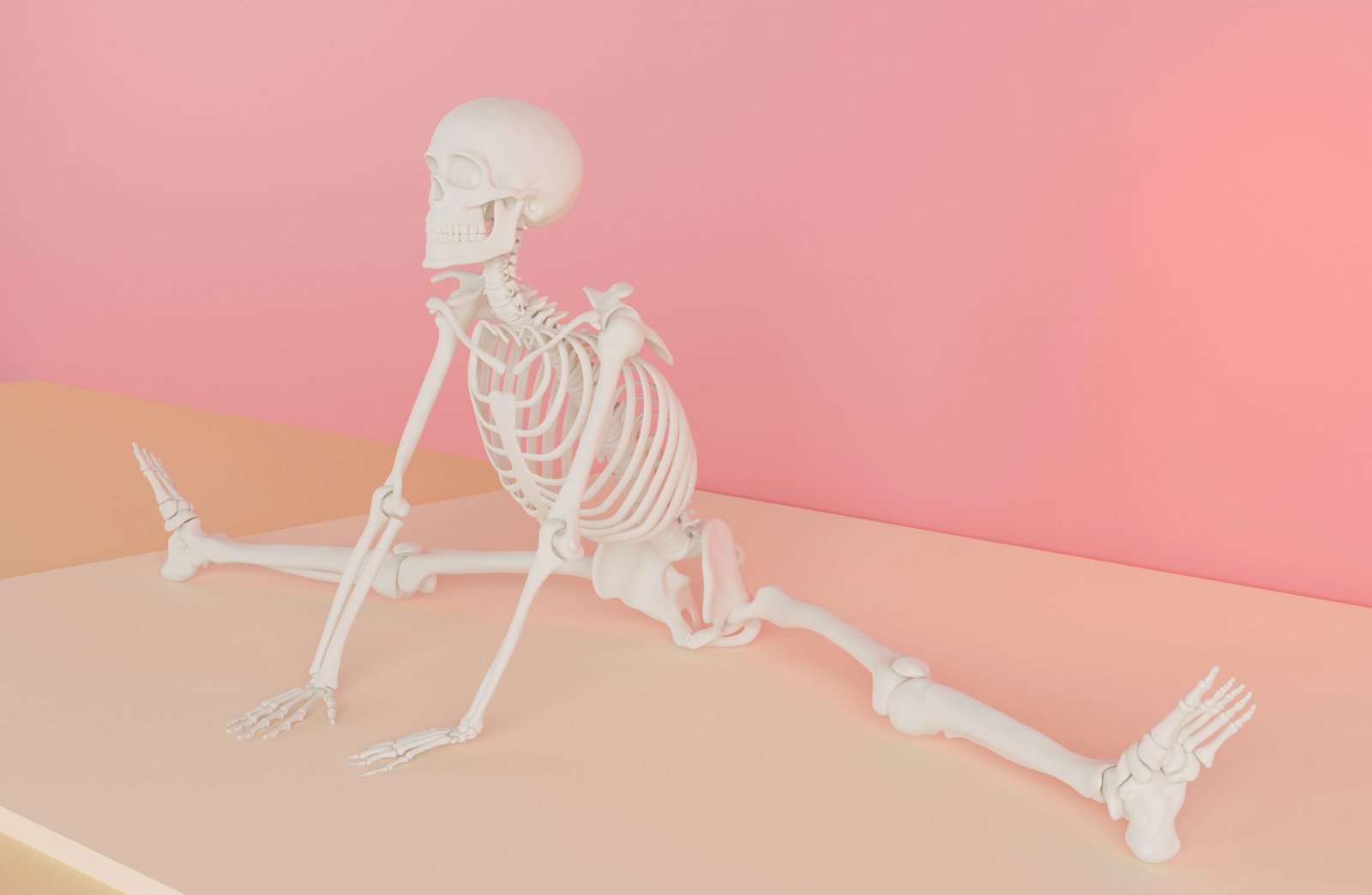 A white skeleton model practicing yoga in a pastel pink room.