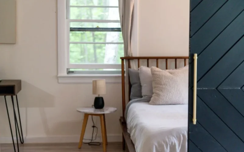 A serene and cozy bedroom interior featuring a comfortable bed and soft lighting, perfect for relaxation.