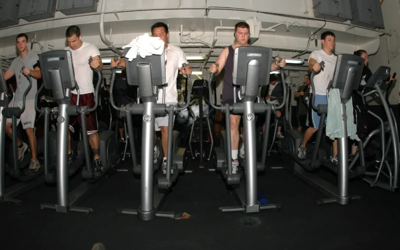PACIFIC OCEAN (April 9, 2007) – Sailors and Marines exercise on elliptical trainers in the hanger bay of the nuclear-powered aircraft carrier USS Nimitz (CVN 68). Nimitz Carrier Strike Group (CSG) is deloyed in support of operations in the U.S. Central Command area of responsibility. U.S. Navy photo by Mass Communication Specialist Seaman Joseph Pol Sebastian Gocong (RELEASED)