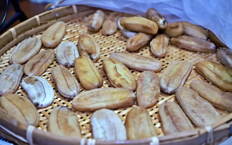 Sun-dried bananas in a traditional woven bamboo tray in Thailand.