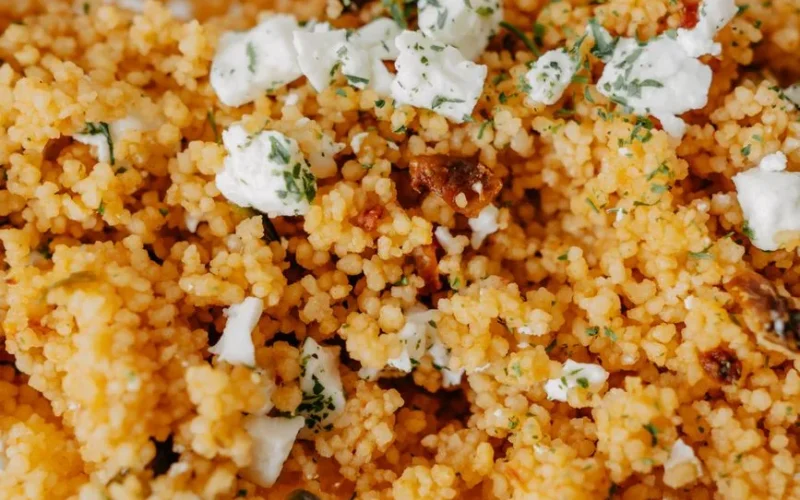 Delicious couscous salad topped with cheese and herbs. A perfect homemade dish featuring fresh ingredients.