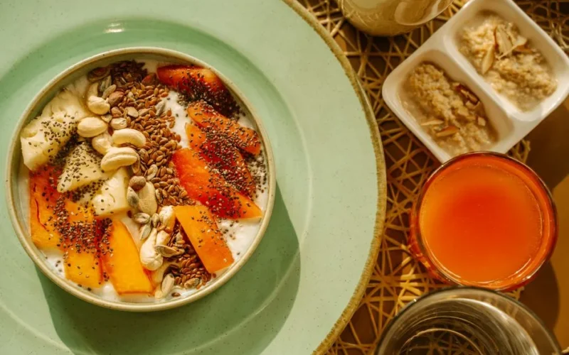 A vibrant breakfast bowl with yogurt, fruits, and seeds, perfect for a healthy morning start.