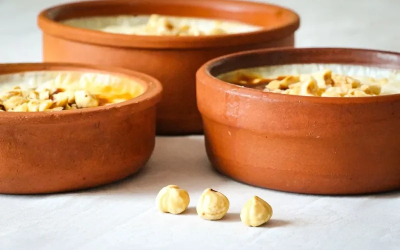 Turkish rice pudding in clay pots topped with nuts, a classic dessert from Türkiye.