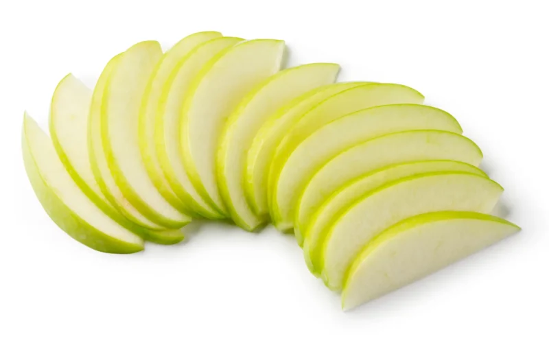Green apple thinly sliced on white background. For more resources, visit the Team Nutrition website at: www.TeamNutrition.usda.gov. All photos are property of USDA with unlimited rights to the use and redistribution of the images.