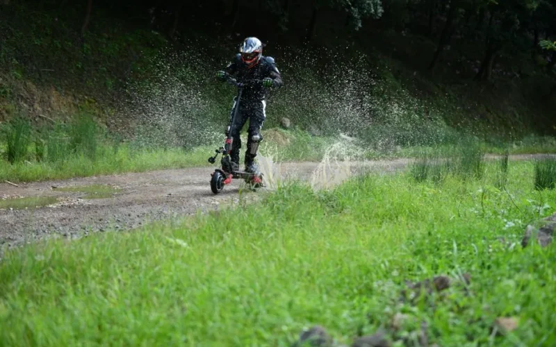 A man riding an electric scooter through a muddy path, splashing water in San Francisco