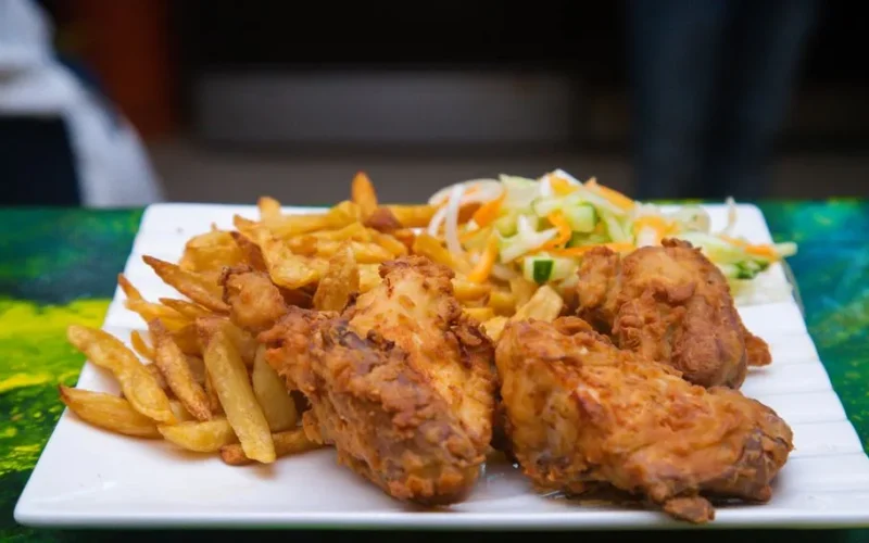 Enjoy a tasty fried chicken meal with crispy fries and fresh salad, perfect for any occasion.