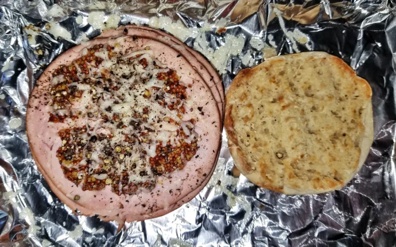 Ham slices, broiled with mustard, cheese, and black pepper on a toasted English muffin - Massachusetts, USA.