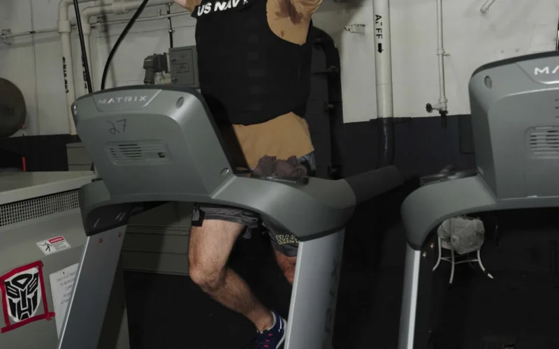 U.S. 5TH FLEET AREA OF OPERATIONS (May 24, 2015) â Lt. j.g. Jack Georges, from New Paltz, New York, runs his first mile in the Murph Challenge aboard the aircraft carrier USS Theodore Roosevelt (CVN 71). The Murph Challenge honors fallen Navy SEAL Lt. Michael Murphy and requires a 1 mile run, 300 squats, 200 push-ups, and 100 pull-ups, finishing with another 1 mile run, all while wearing a 20-pound weighted vest. Theodore Roosevelt is deployed in the U.S. 5th Fleet area of operations supporting Operation Inherent Resolve, strike operations in Iraq and Syria as directed, maritime security operations and theater security cooperation efforts in the region. (U.S. Navy photo by Mass Communication Specialist 3rd Class Kris R. Lindstrom/Released)