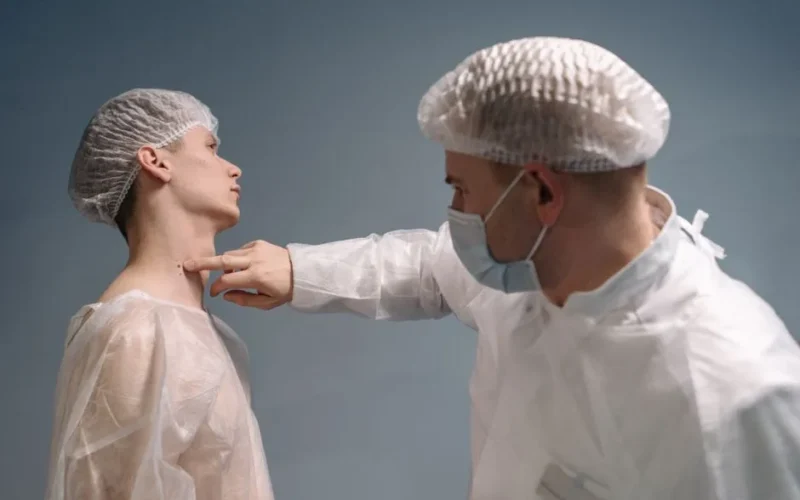 A doctor evaluates a patient's skin condition in a clinical setting with appropriate medical attire.