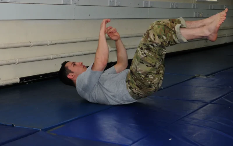 Staff Sgt. Matt Carlino, 100th Operations Support Squadron Survival, Evasion, Resistance and Escape specialist, demonstrates “eos” – one of many abdominal workouts – as part of the warm-up for the Modern Army Combative Program course May 17, 2012, at RAF Feltwell. Carlino taught the four-day course to five military members from RAF Mildenhall. Students had to perform a variety of exercises to warm up and stretch their muscles before practicing the moves they had learned one-on-one. As a SERE specialist, he was trained at the Army training MACP school at Fort Benning, Ga.