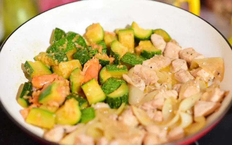 Savory chicken and zucchini stir fry cooked to perfection in a pan.