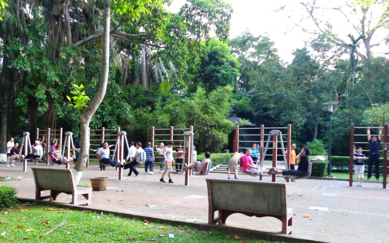 People exercising on exercise equipment in Haikou People's Park, Haikou City, Hainan Province, China