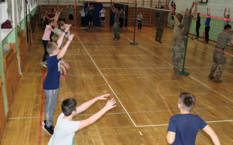 U.S. Army Soldiers assigned to 2nd Battalion, 12th Cavalry Regiment, 1st Armored Brigade Combat Team, 1st Cavalry Division, guide students through warm up exercises during a physical education class at a school in Valga, Estonia, Dec. 13, 2018. The Soldiers are in Estonia in support of the 1st ABCT Atlantic Resolve rotation across Europe, which is to improve the interoperability between U.S. Forces and their NATO allies and partners.