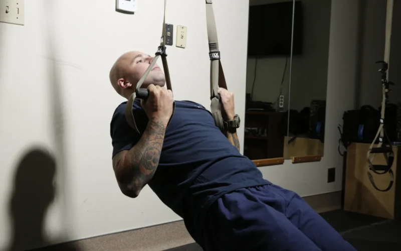 David Pacileo, firefighter with the Marine Corps Logistics Base Barstow, Calif., Security and Emergency Services Fire Department, trains with the TRX system at the Yermo Annex fire station on May 26. Pacileo, other firefighters, and deployed service members use the system to maintain physical fitness while working state side and deployed. Unit: Marine Corps Logistics Base Barstow