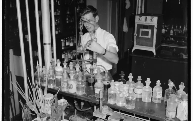 Title: Cosmetics tested at Department of Agriculture. Washington D.C., July 10. In hair dyes and hair tonics there is sometimes found lead acetate, this is absorbed slowly into the system where it accumulates and may result in chronic poisoning. D.H. McCarter, of the Department of Agriculture is shown determining the amount of alcohol in a hair tonic by the method of distillation... Abstract/medium: 1 negative : glass ; 4 x 5 in. or smaller