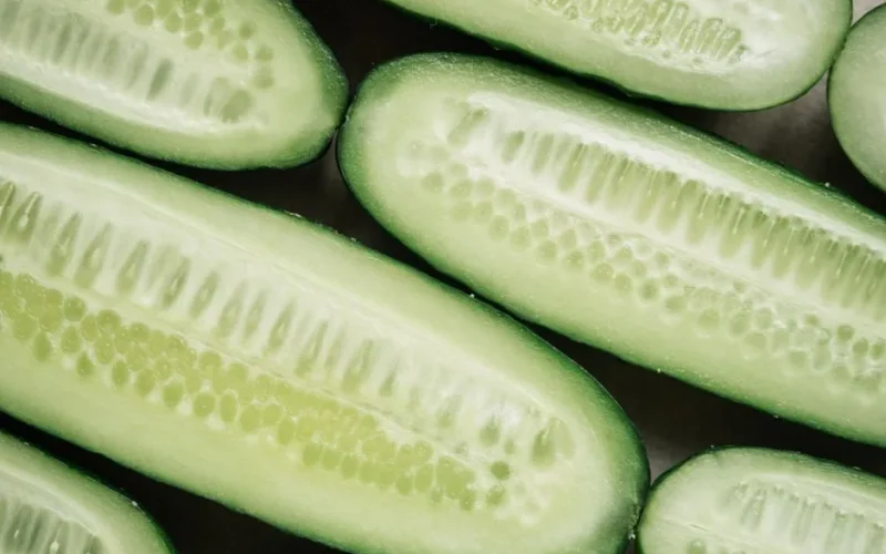 High-resolution close-up image of fresh sliced cucumbers showcasing their texture.
