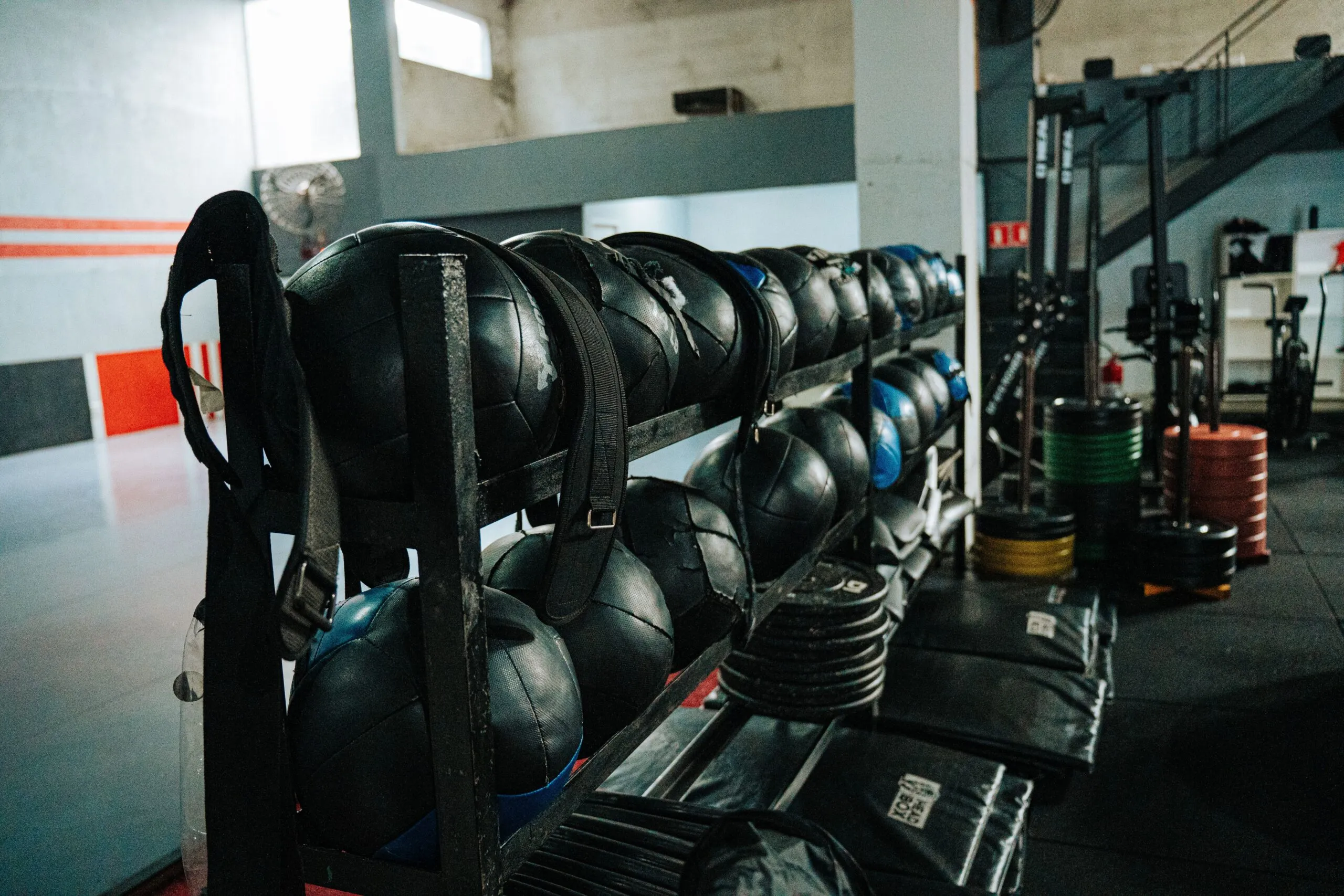 Well-equipped indoor gym featuring kettlebells, weights, and workout gear, perfect for fitness enthusiasts.