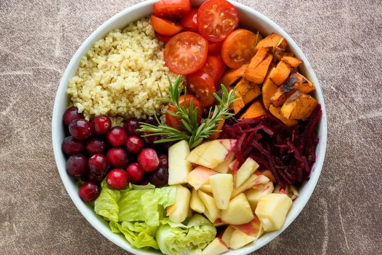 A vibrant Buddha bowl filled with quinoa, fresh fruits, and vegetables. Perfect for a healthy meal plan.
