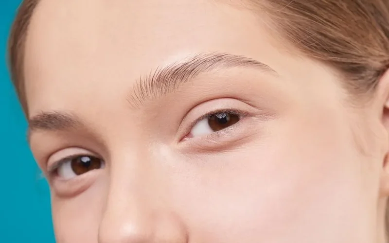 A close-up photo showcasing a woman's natural skin and eye detail, emphasizing natural beauty.